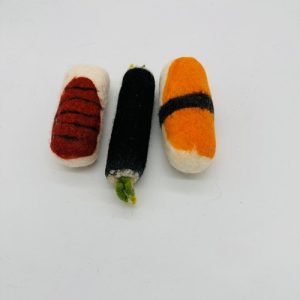 A handmade felt turtle pet toy with a green body and yellow shell spots, featuring small white eyes.