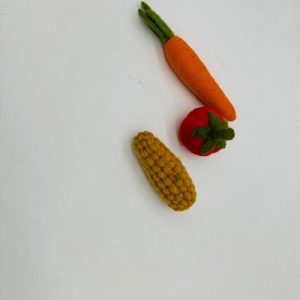 A handmade felt turtle pet toy with a green body and yellow shell spots, featuring small white eyes.