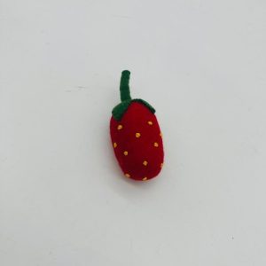 A handmade felt turtle pet toy with a green body and yellow shell spots, featuring small white eyes.