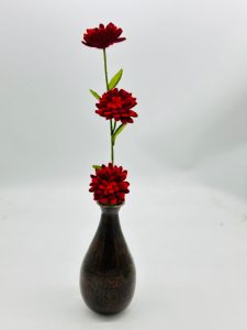 Handmade felt flower with layered petals.