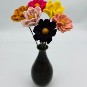 Handmade felt flower with layered petals.