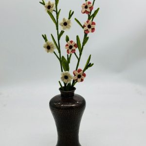 Handmade felt flower with layered petals.