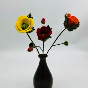 Handmade felt flower with layered petals.