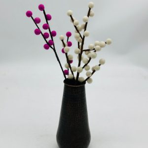 Handmade felt flower with layered petals.