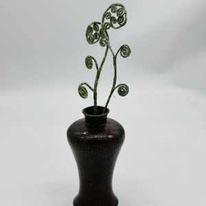 Handmade felt flower with layered petals.