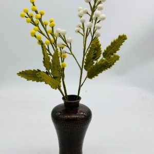 Handmade felt flower with layered petals.