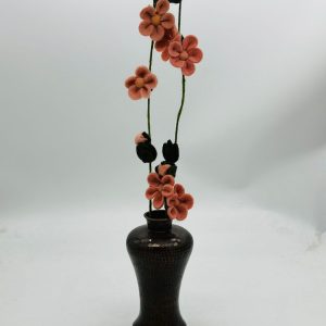 Handmade felt flower with layered petals.