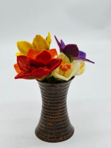 Handmade felt flower with layered petals.