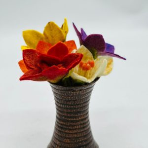 Handmade felt flower with layered petals.