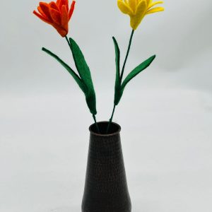 Handmade felt flower with layered petals.