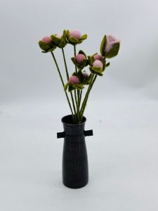 Handmade felt flower with layered petals.