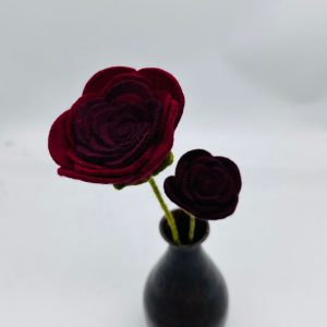 Handmade felt flower with layered petals.