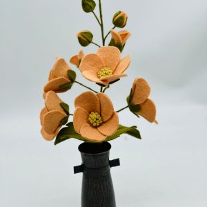 Handmade felt flower with layered petals.