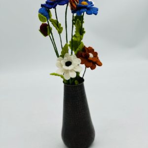 Handmade felt flower with layered petals.