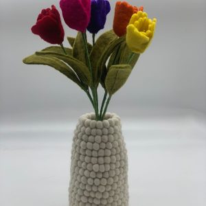 Handmade felt flower with layered petals.